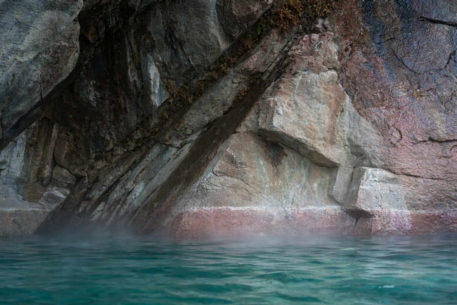 Aska Thermal Spa under red granite cliffs