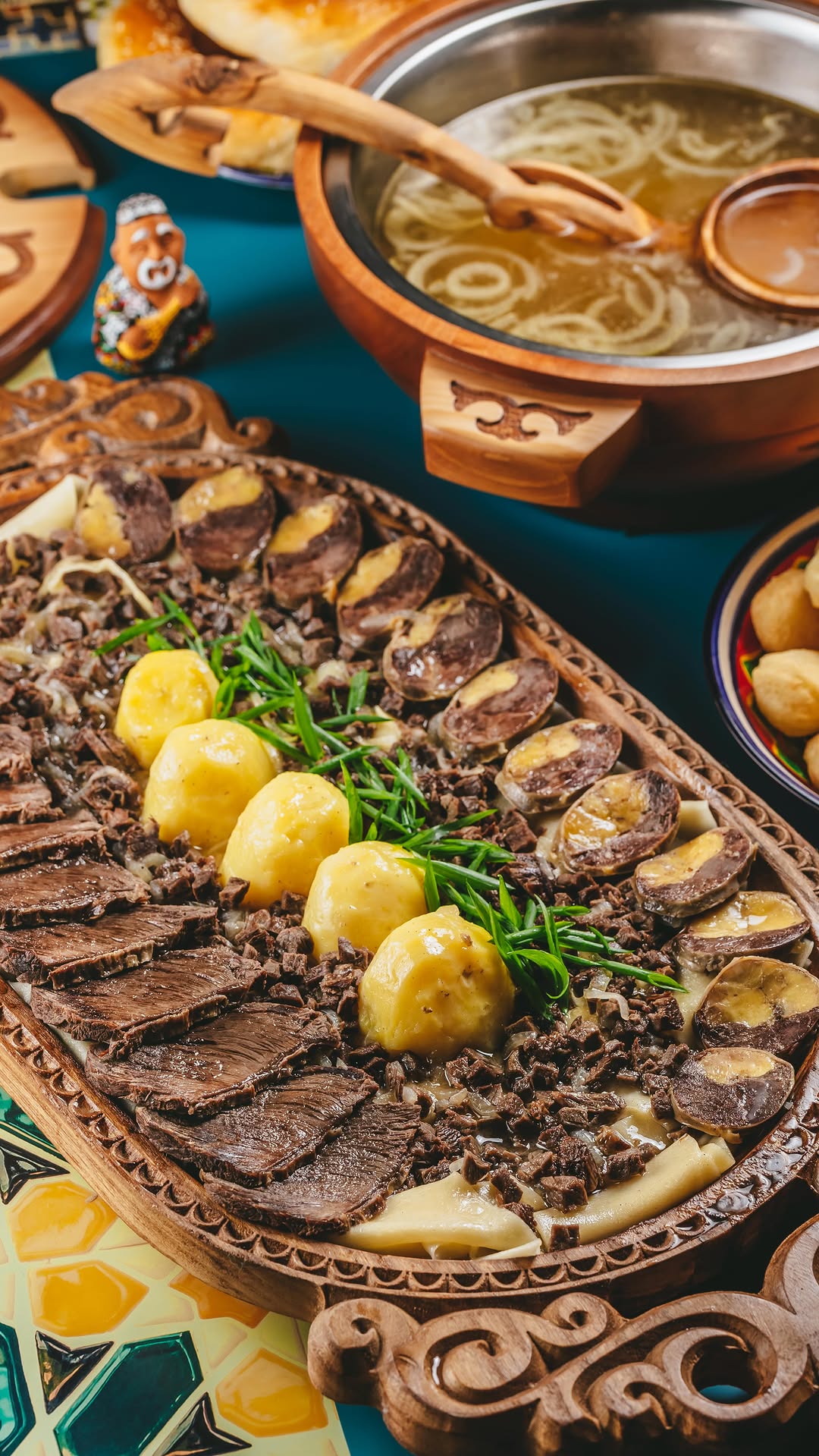 Beshbarmak served with noodles and onion broth