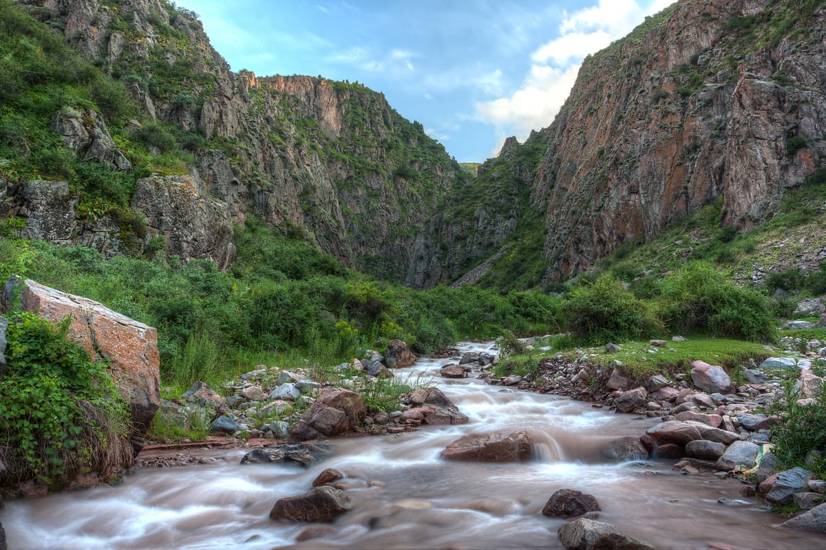 Mountain river and meadows in Chunkurchak